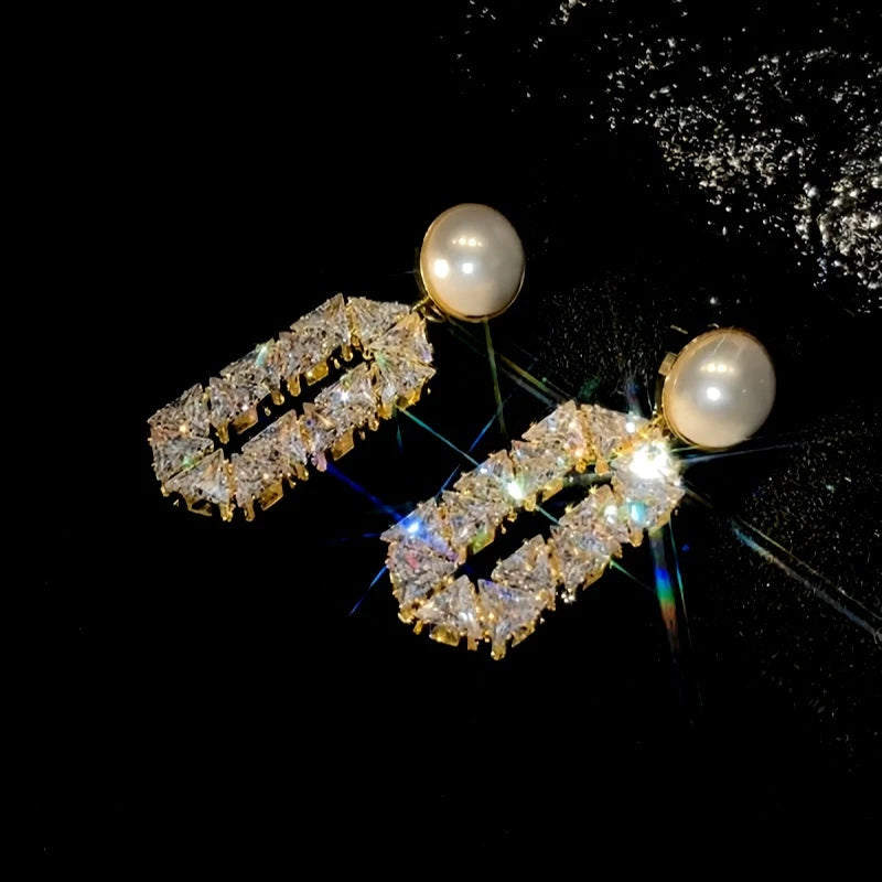 Model showcasing the dangle and style of the 14K Gold-Plated Elegant Zircon Diamond Pearl Earrings