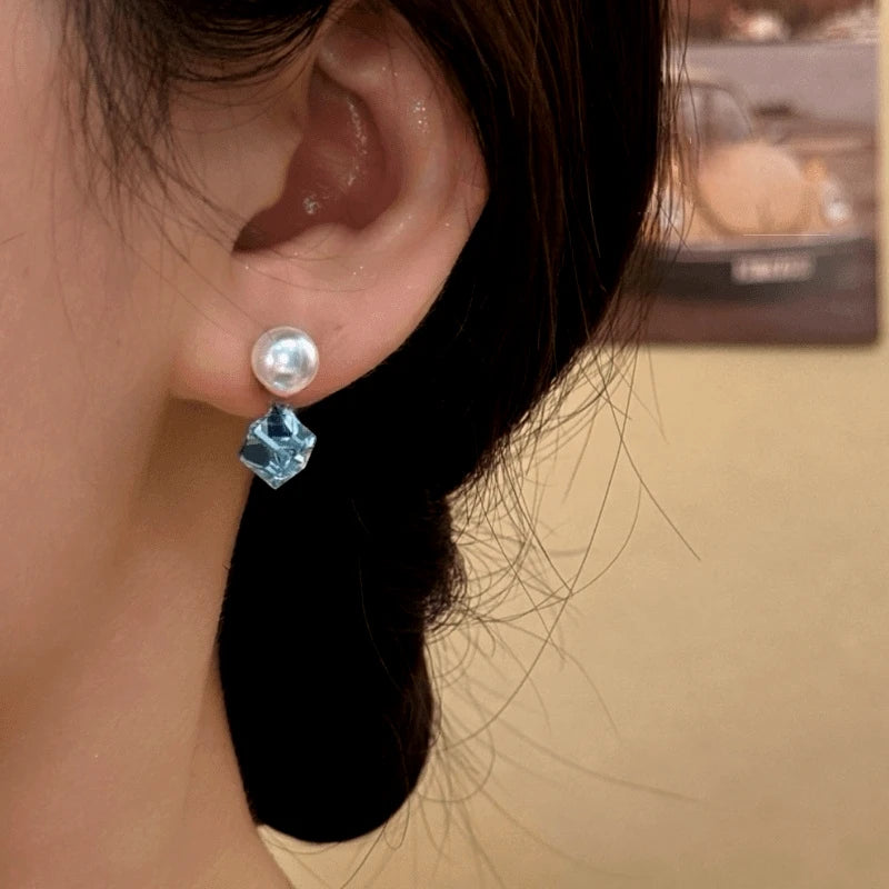 Model showcasing the dangle and style of the 14K Gold-Plated Elegant Zircon Diamond Pearl Earrings