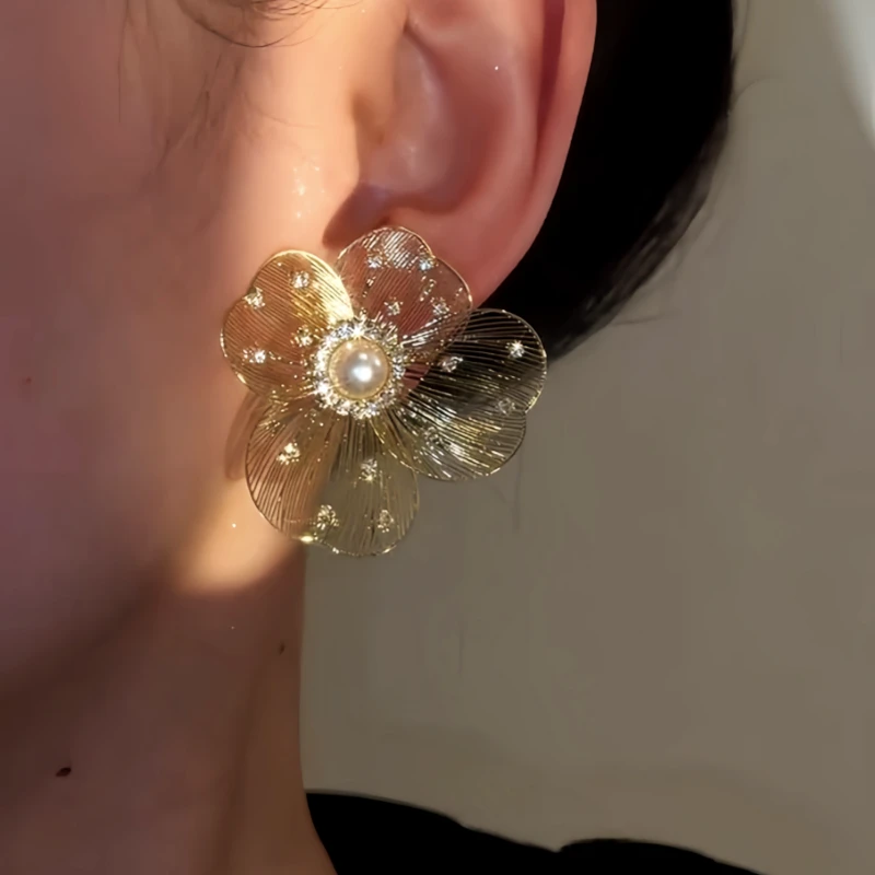 Model showcasing the dangle and style of the 14K Gold-Plated Elegant Zircon Diamond Pearl Large Flower Stud Earrings