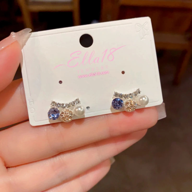 Model showcasing the dangle and style of the 14K Gold-Plated Elegant Zircon Diamond Pearl Stud Earrings