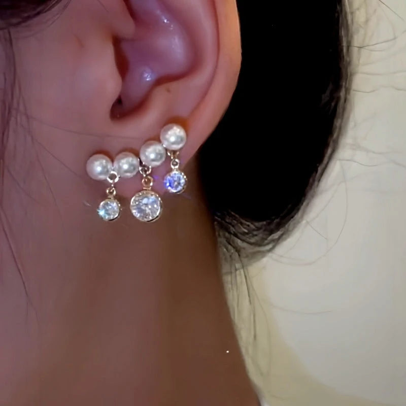 Model showcasing the dangle and style of the 14K Gold-Plated Elegant Zircon Diamond Pearl Tassel Earrings