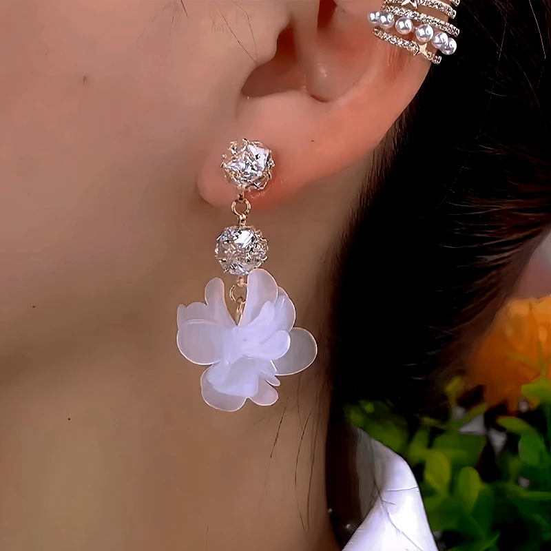 Model showcasing the dangle and style of the 14K Gold-Plated Elegant Zircon Diamond Petal Flower Earrings
