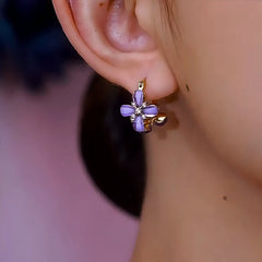 Model showcasing the dangle and style of the 14K Gold-Plated Elegant Zircon Diamond Purple Flower Earrings