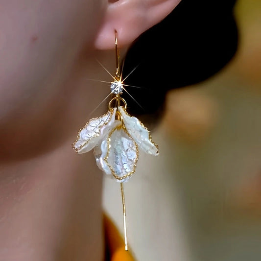 Model showcasing the dangle and style of the 14K Gold-Plated Elegant Zircon Diamond Shell Threader Earrings