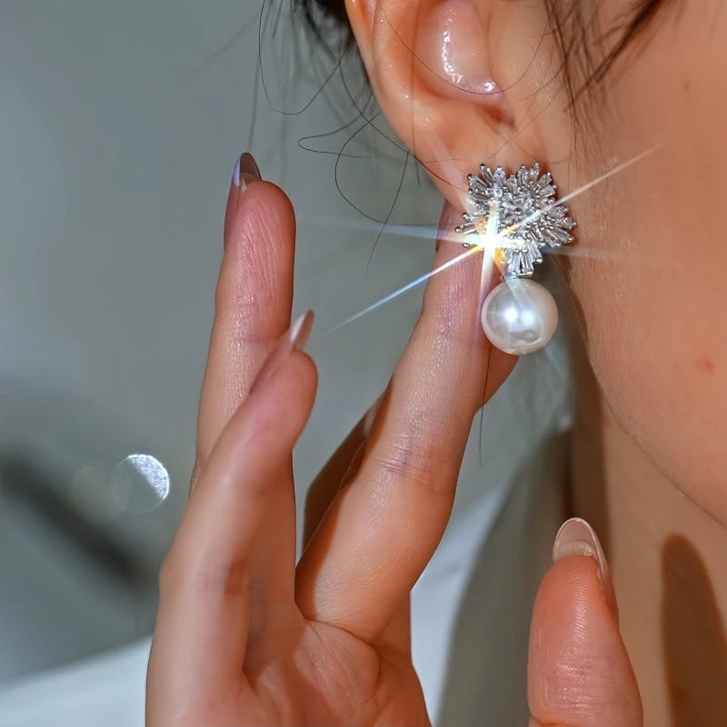 Angled view of the 14K Gold-Plated Elegant Zircon Diamond Snowflake Pearl Earrings