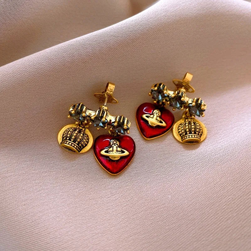 Angled view of the 14K Gold-Plated Elegant Zircon Diamond Star And Heart Saturn Earrings