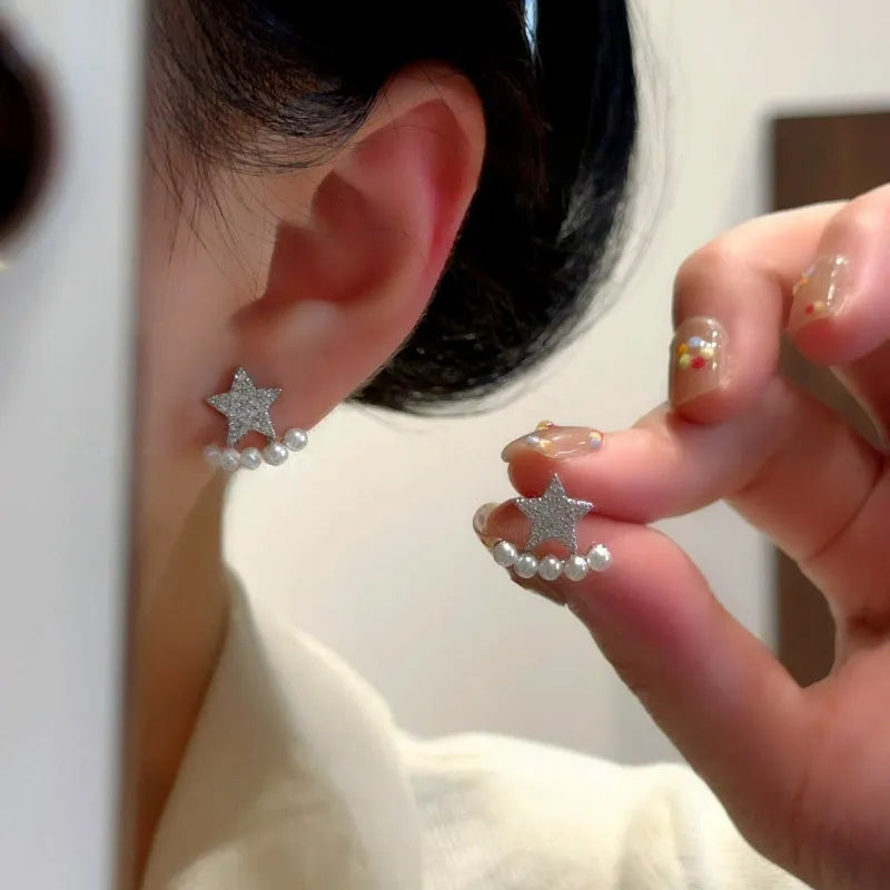 Model showcasing the dangle and style of the 14K Gold-Plated Elegant Zircon Diamond Star Bead Jacket Earrings