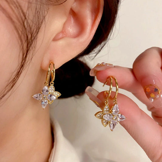 Model showcasing the dangle and style of the 14K Gold-Plated Elegant Zircon Diamond Star Earrings
