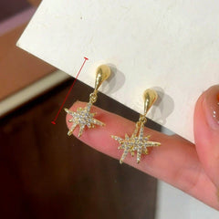 Close-up detail of the sparkling zircons and plating on the Star Dangle Earrings