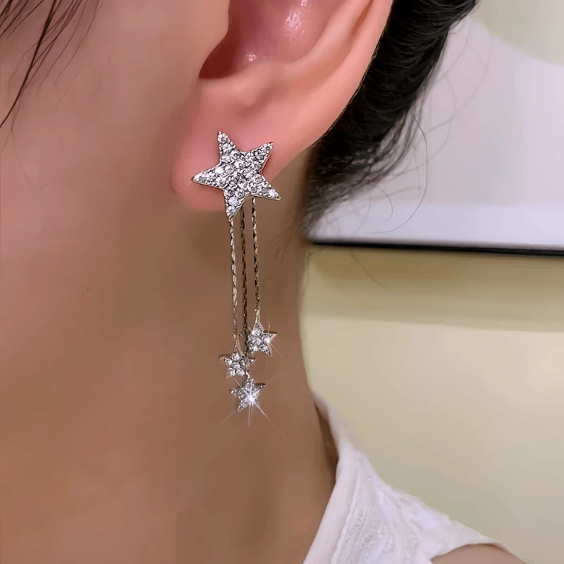 Model showcasing the dangle and style of the 14K Gold-Plated Elegant Zircon Diamond Star Tassel Earrings