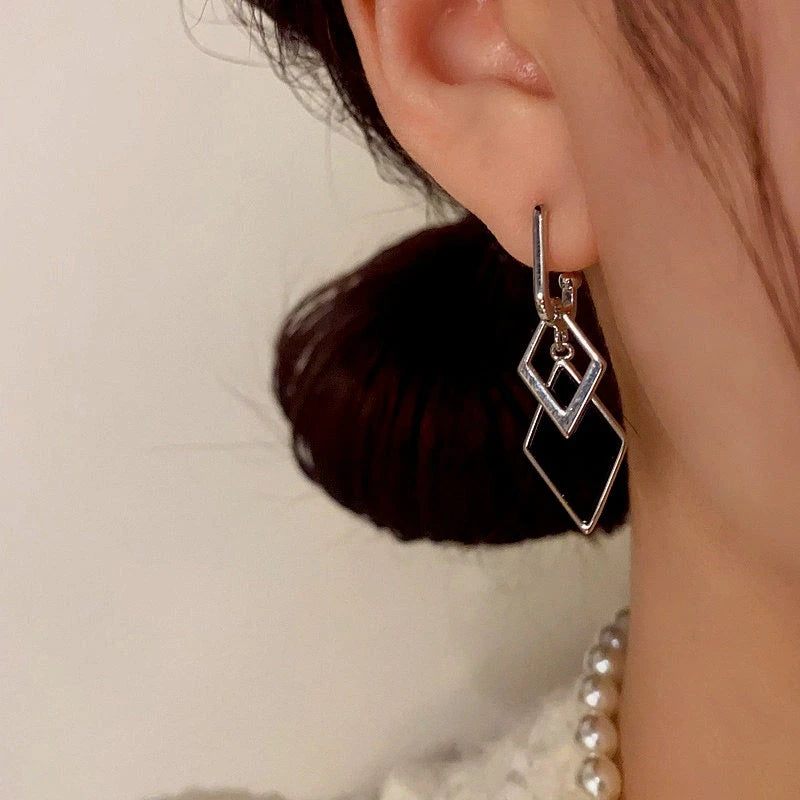 Model showcasing the dangle and style of the 14K Gold-Plated Elegant Zircon Diamond Tassel Earrings