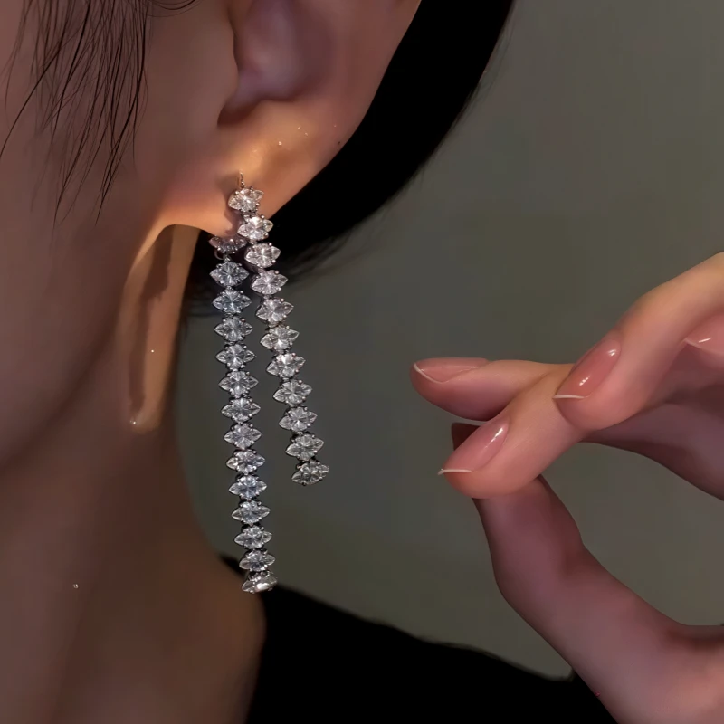 Model showcasing the dangle and style of the 14K Gold-Plated Elegant Zircon Diamond Tassel Earrings