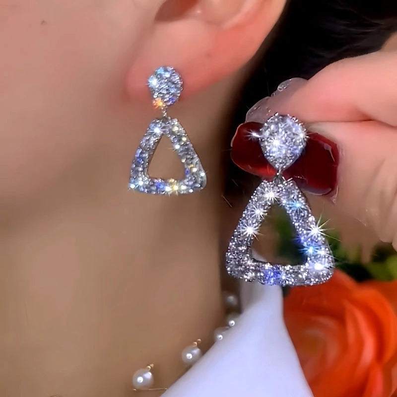 Model showcasing the dangle and style of the 14K Gold-Plated Elegant Zircon Diamond Tassel Earrings