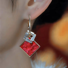 Close-up detail of the sparkling zircons and plating on the Red Tassel Earrings