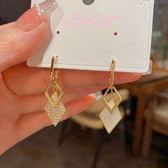 Close-up detail of the sparkling zircons and plating on the Gold Tassel Earrings