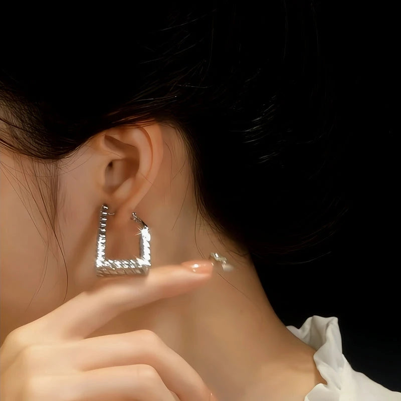 Model showcasing the dangle and style of the 14K Gold-Plated Elegant Zircon Diamond Trapezoidal Earrings