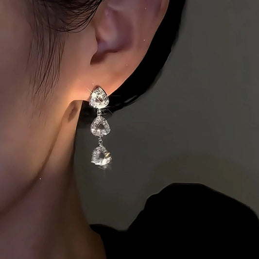 Model showcasing the dangle and style of the 14K Gold-Plated Elegant Zircon Diamond Triangle Earrings