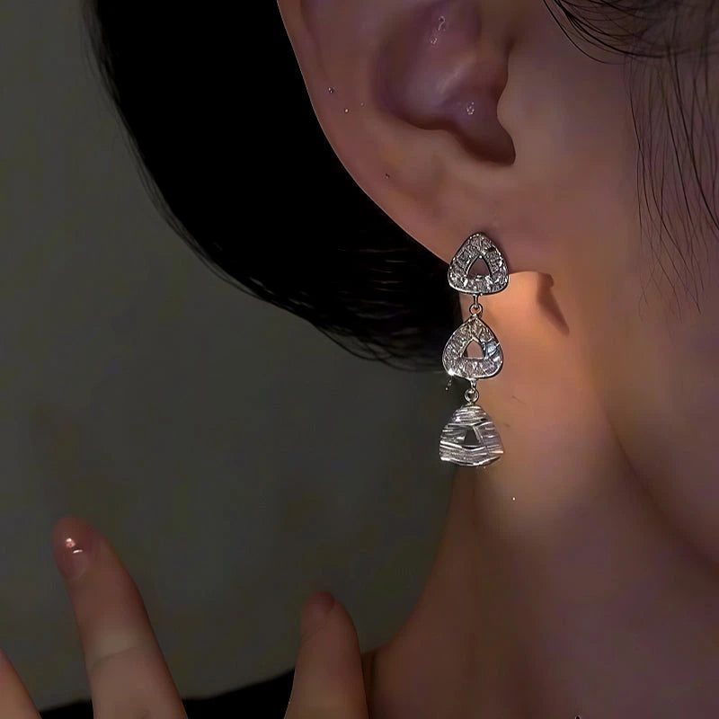 Close-up detail of the sparkling zircons and plating on the Triangle Earrings