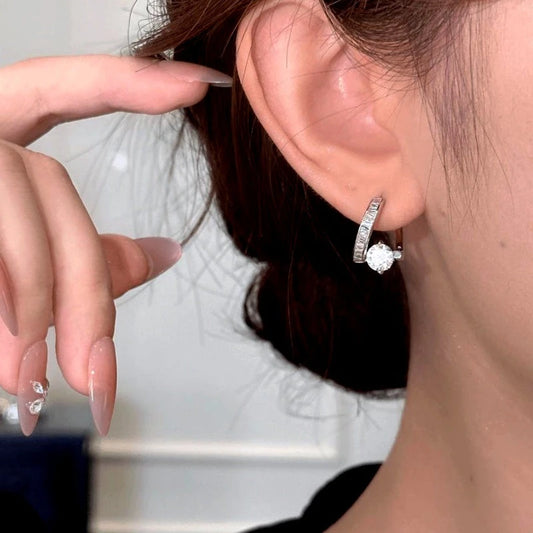 Model showcasing the dangle and style of the 14K Gold-Plated Elegant Zircon Diamond Twisted Earrings