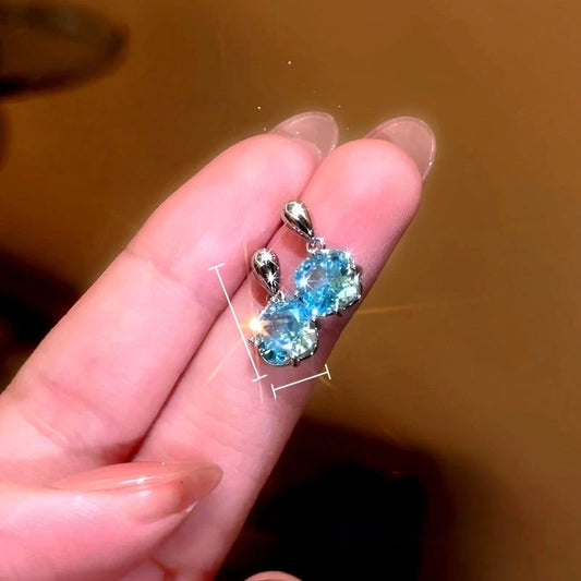 Model showcasing the dangle and style of the 14K Gold-Plated Elegant Zircon Diamond Water Drop Earrings