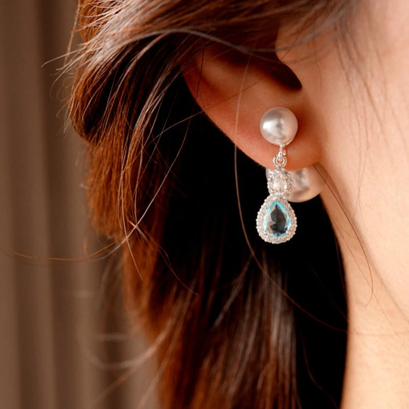 Model showcasing the dangle and style of the 14K Gold-Plated Elegant Zircon Diamond Water Drop Pearl Jacket Earrings