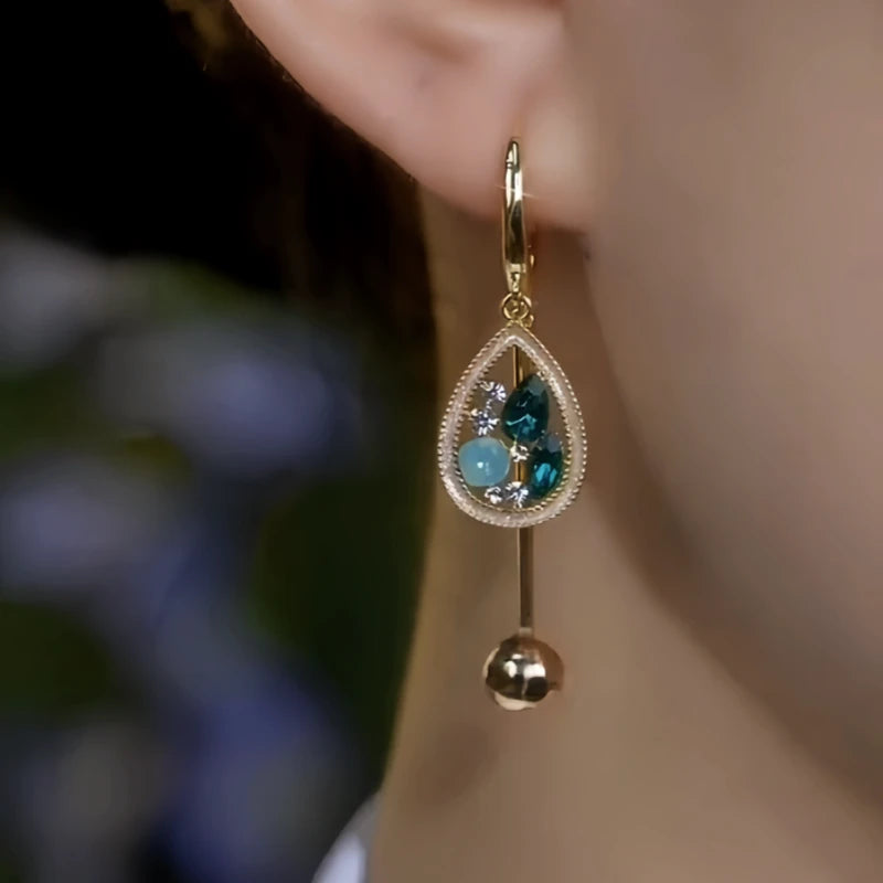 Model showcasing the dangle and style of the 14K Gold-Plated Elegant Zircon Diamond Water Drop Tassel Earrings