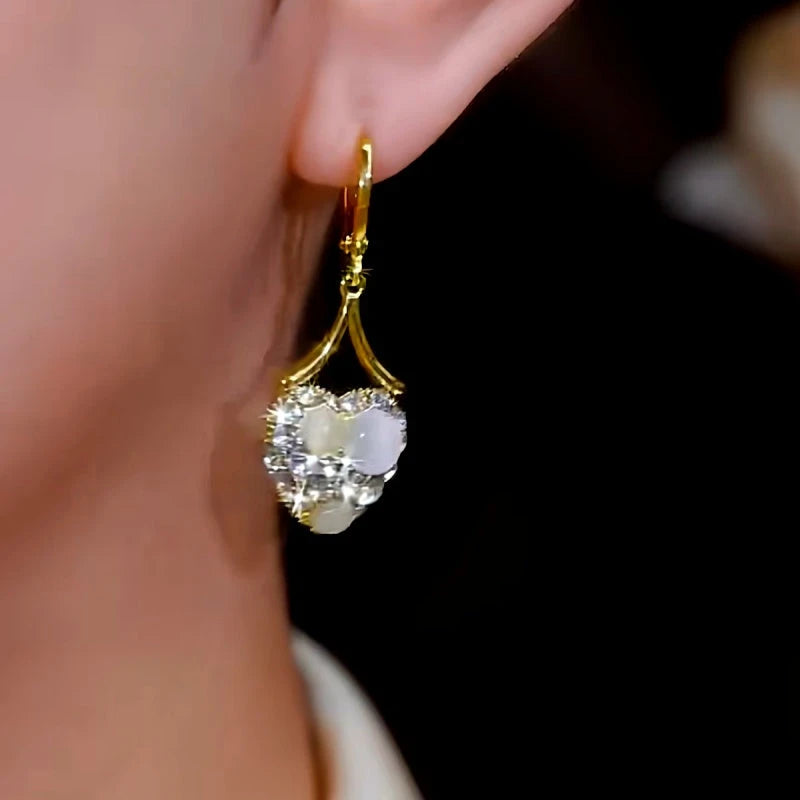 Close-up detail of the sparkling zircons and plating on the White Heart Earrings