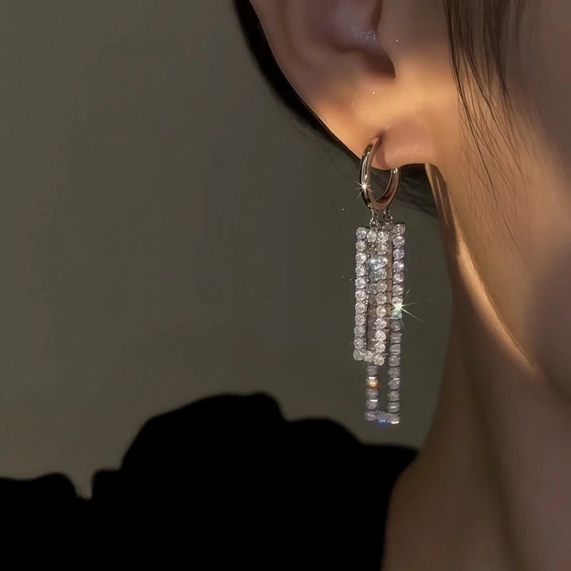 Model showcasing the dangle and style of the 14K Gold-Plated Elegant Zircon Diamoond Tassel Earrings