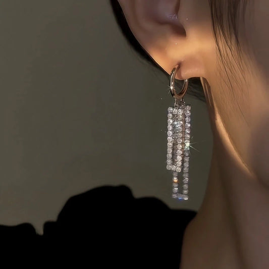Model showcasing the dangle and style of the 14K Gold-Plated Elegant Zircon Diamoond Tassel Earrings