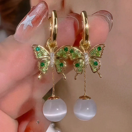 Model showcasing the dangle and style of the 14K Gold-Plated Elegant Zircon Diiamond Butterfly Cat's Eye Stone Earrings