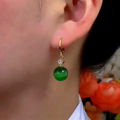 Model showcasing the dangle and style of the 14K Gold-Plated Elegant Zircon Diiamond Cat's Eye Stone Earrings