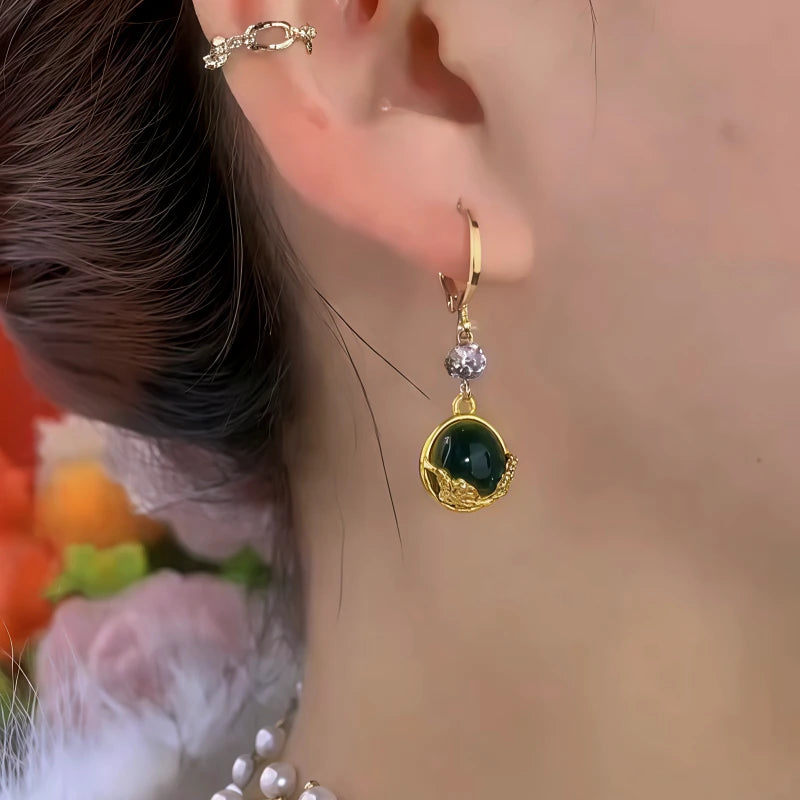 Model showcasing the dangle and style of the 14K Gold-Plated Elegant Zircon Diiamond Green Cat Eye Stone Earrings