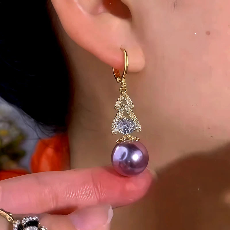 Model showcasing the dangle and style of the 14K Gold-Plated Elegant Zircon Diiamond Pearl Earrings