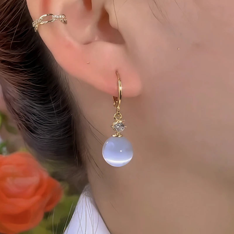 Close-up detail of the sparkling zircons and plating on the White Cat's Eye Earrings
