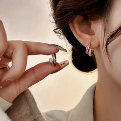 Model showcasing the dangle and style of the 14K Gold-Plated Elegant Zircon Double-Layer Earrings