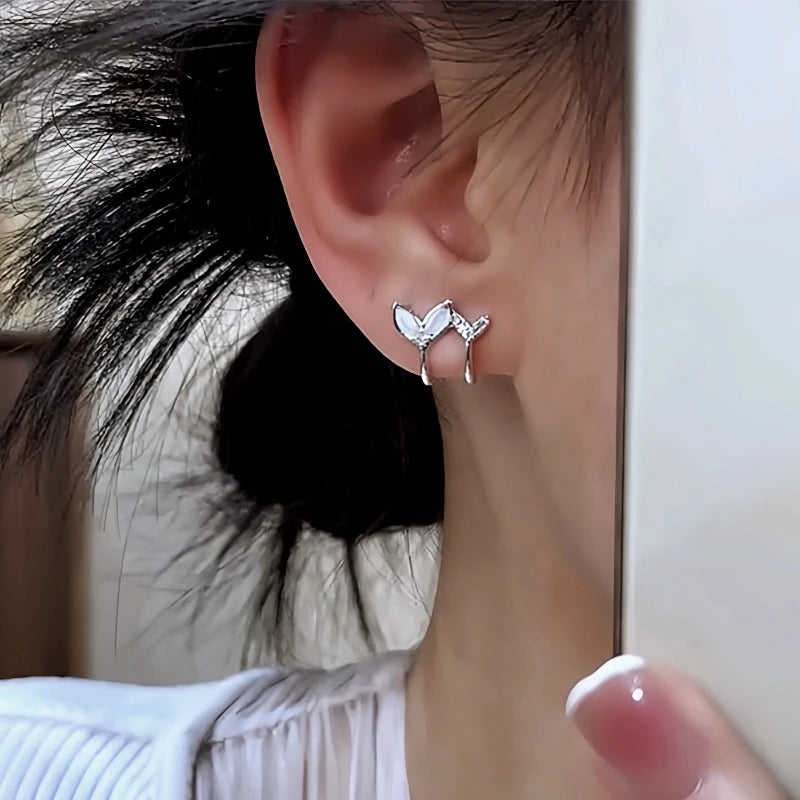 Model showcasing the dangle and style of the 14K Gold-Plated Elegant Zircon Double-Layer Fishtail Stud Earrings