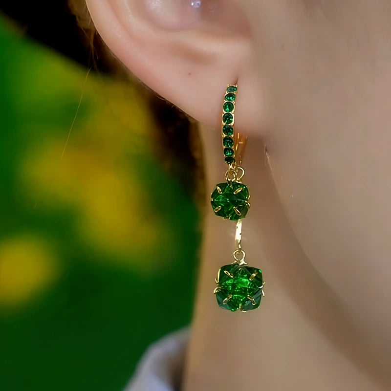 Model showcasing the dangle and style of the 14K Gold-Plated Elegant Zircon Double-Layer Green Diamond Ball Earrings