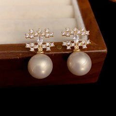 Close-up detail of the sparkling zircons and plating on the Double C Earrings