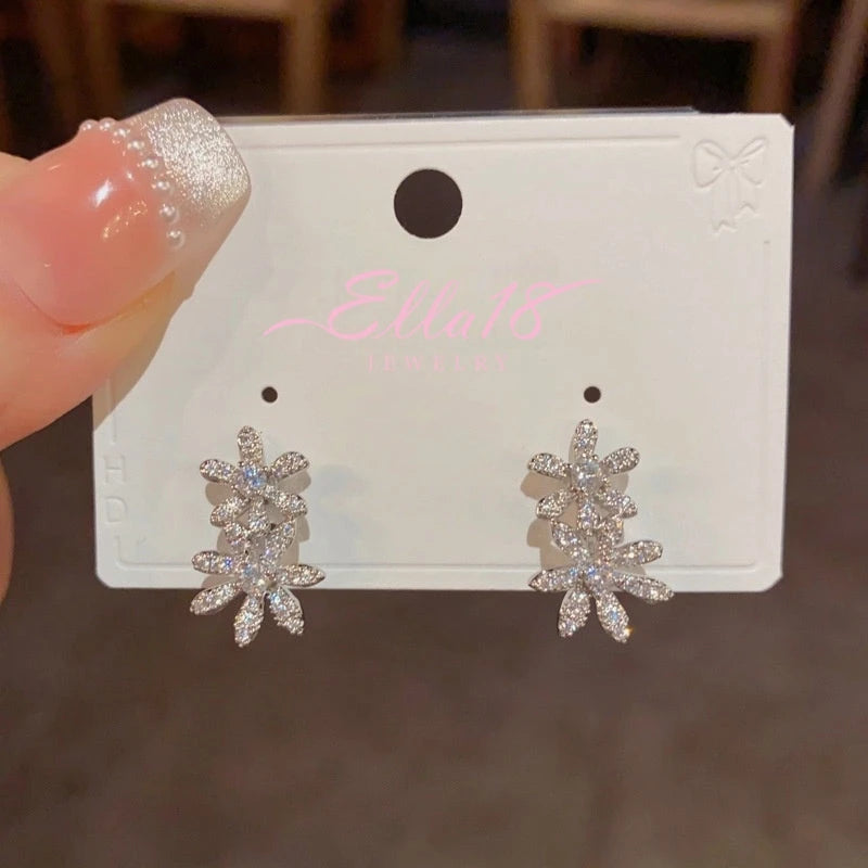 Model showcasing the dangle and style of the 14K Gold-Plated Elegant Zircon Double Flowe Pearl Jacket Earrings