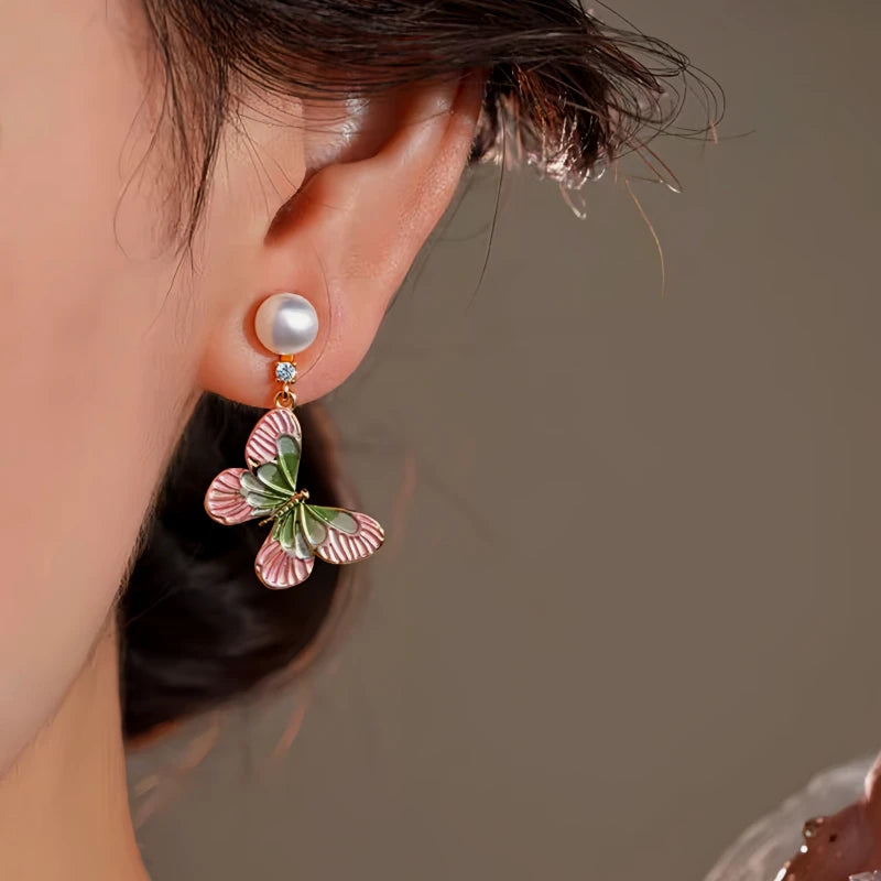 Model showcasing the dangle and style of the 14K Gold-Plated Elegant Zircon Enamel Butterfly Pearl Tassel Earrings