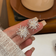 Model showcasing the dangle and style of the 14K Gold-Plated Elegant Zircon Firework Stud Earrings