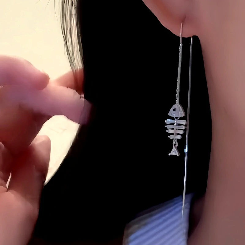 Model showcasing the dangle and style of the 14K Gold-Plated Elegant Zircon Fishbone Tassel Threader Earrings