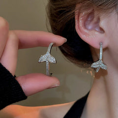 Model showcasing the dangle and style of the 14K Gold-Plated Elegant Zircon Fishtail C-Shaped Earrings