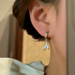 Close-up detail of the sparkling zircons and plating on the Fishtail Tassel Earrings
