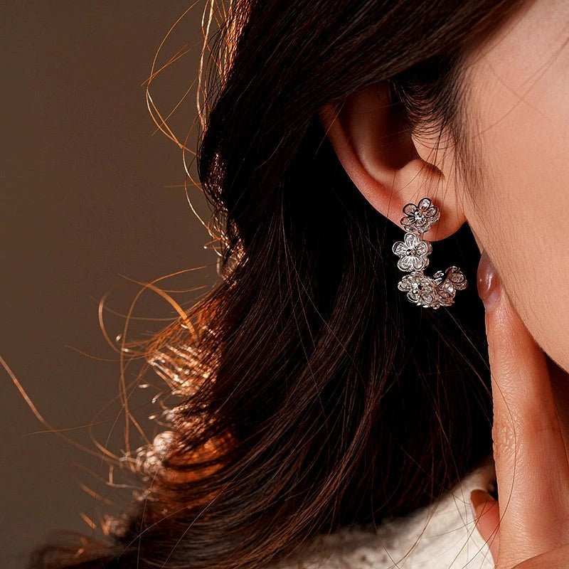 Close-up detail of the sparkling zircons and plating on the Flower C-Shaped Hoops