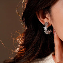 Close-up detail of the sparkling zircons and plating on the Flower C-Shaped Hoops