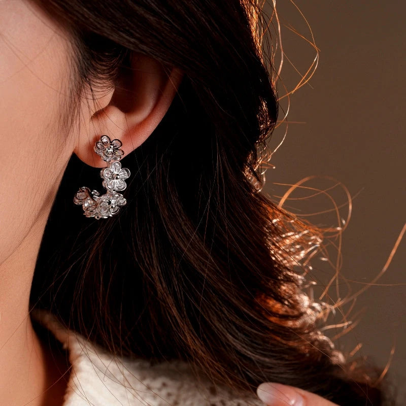 Model showcasing the dangle and style of the 14K Gold-Plated Elegant Zircon Flower C-Shaped Earrings