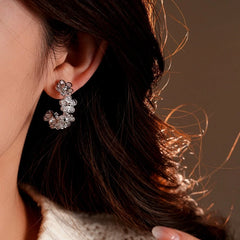 Model showcasing the dangle and style of the 14K Gold-Plated Elegant Zircon Flower C-Shaped Earrings