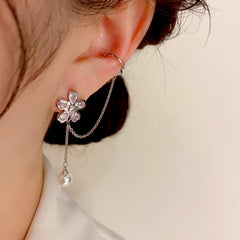 Model showcasing the dangle and style of the 14K Gold-Plated Elegant Zircon Flower Ear Clip Tassel Earrings