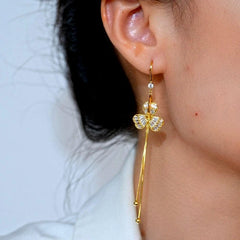 Model showcasing the dangle and style of the 14K Gold-Plated Elegant Zircon Flower Ear Hook Earrings